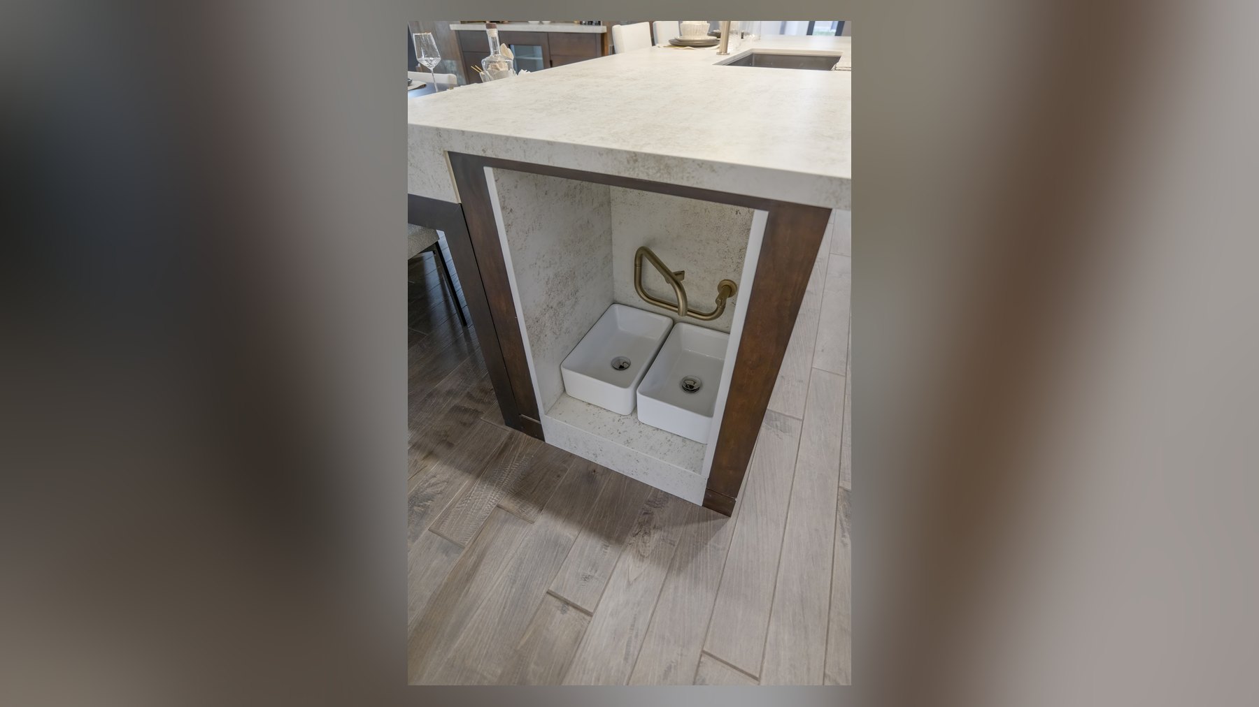 Built-in pet bowls and brass filler under the kitchen island